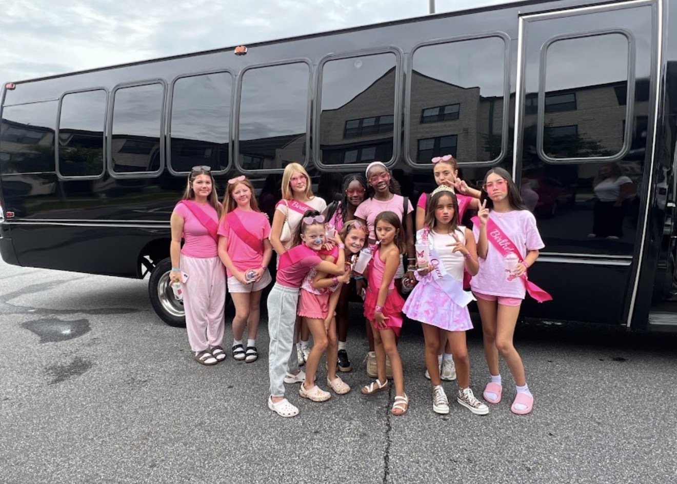 Birthday group beside a Play-It-Safe party bus