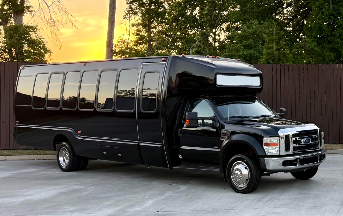 Play-It-Safe 26-passenger party bus exterior at sunset showcasing the full vehicle