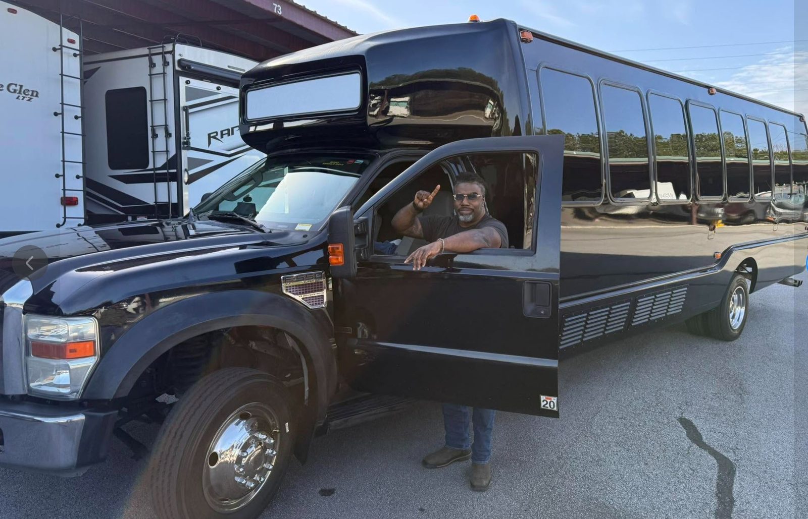 Play-It-Safe 26-passenger party bus exterior, driver ready for pickup