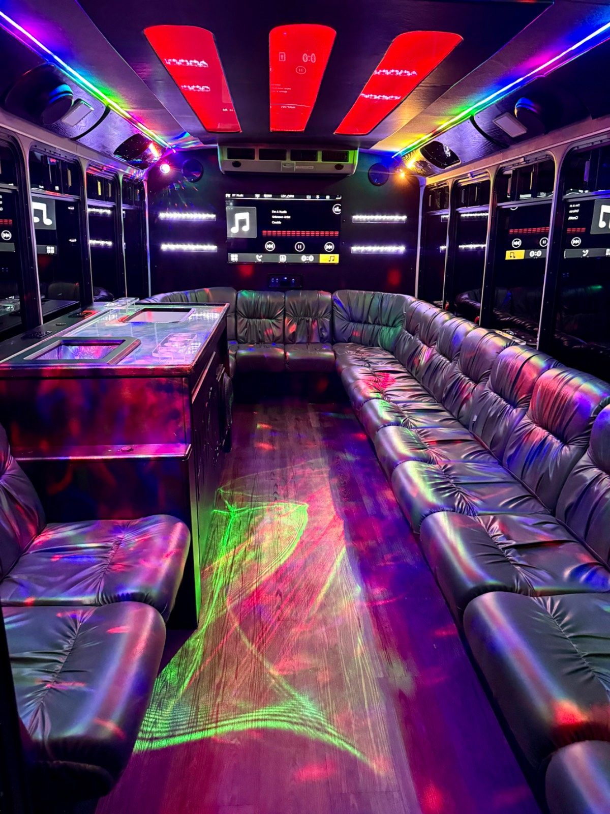 18-passenger Play-It-Safe party bus interior with red LED mood lighting