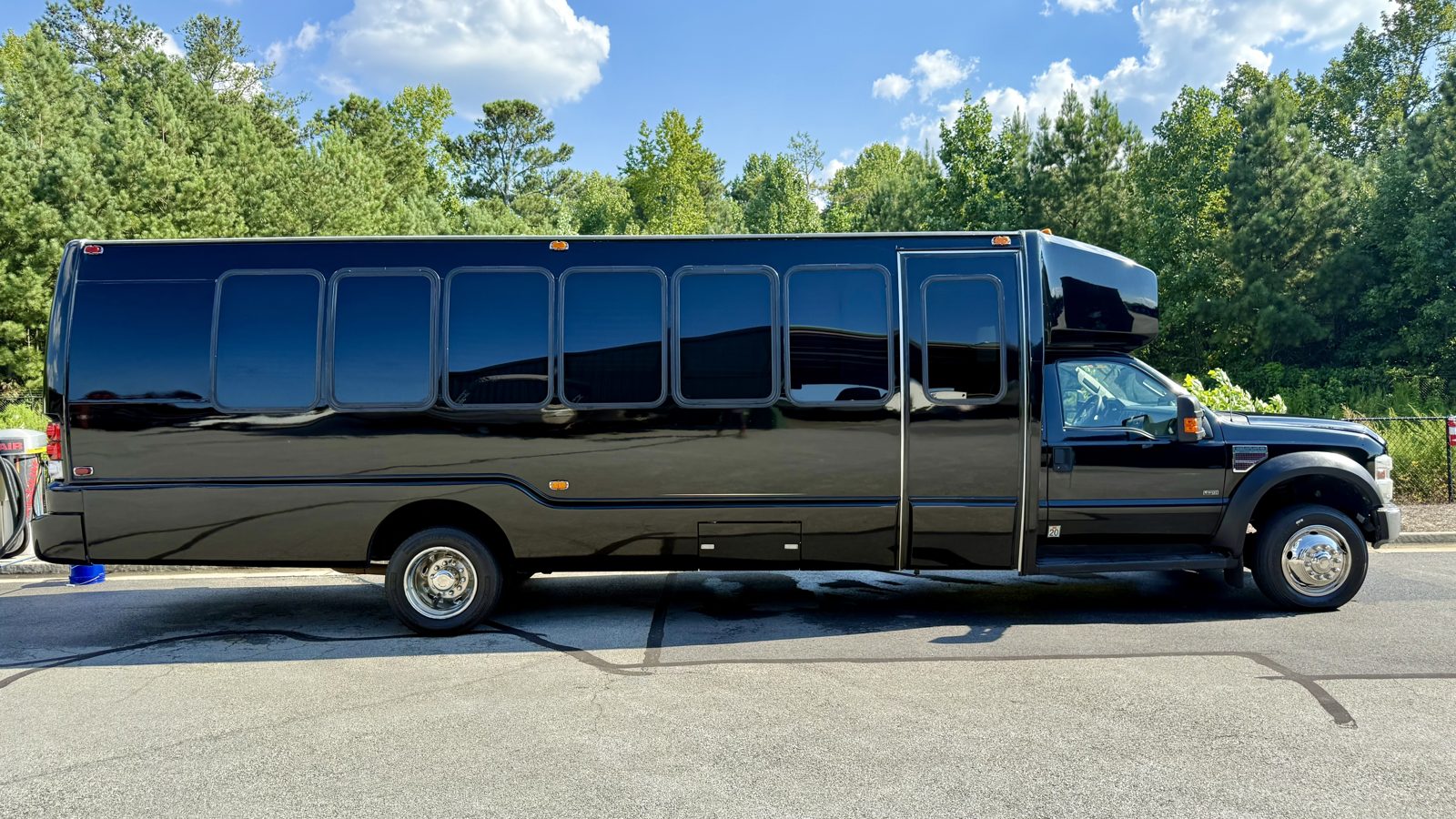 26-passenger Play-It-Safe party bus full side profile exterior on a sunny day
