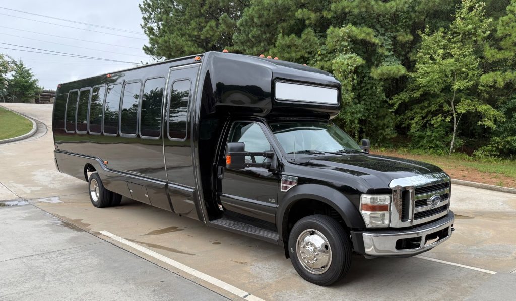 26-passenger Play-It-Safe party bus exterior parked among trees