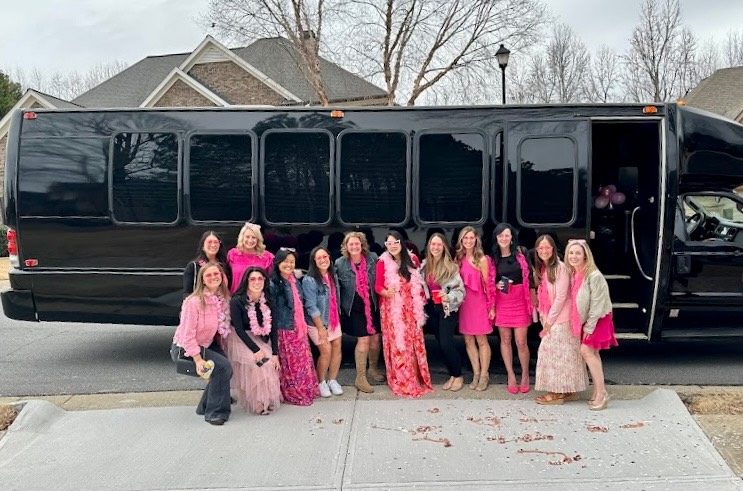 Bachelorette group celebrating in front of the 26-passenger Play-It-Safe party bus