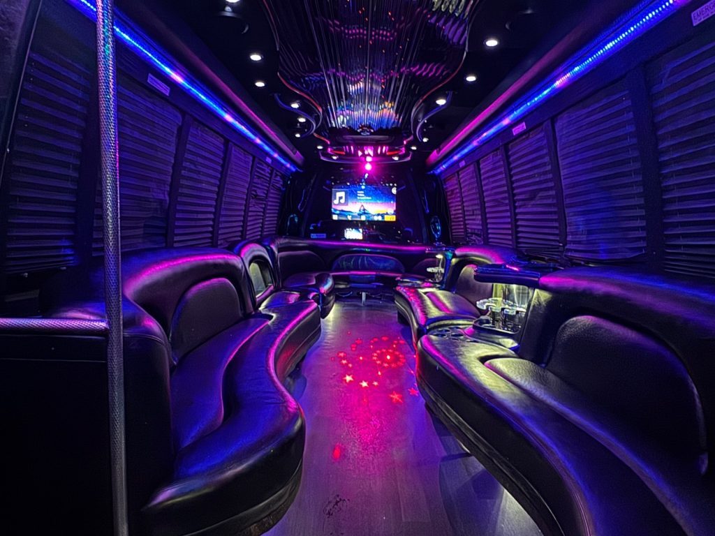 26-passenger Play-It-Safe party bus interior with purple LED lighting
