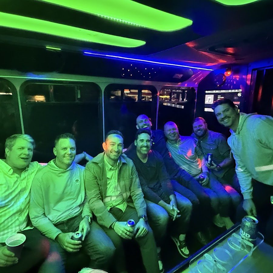 Guests enjoying colorful party bus lighting